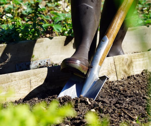 person digging with shovel - contact 811 before digging